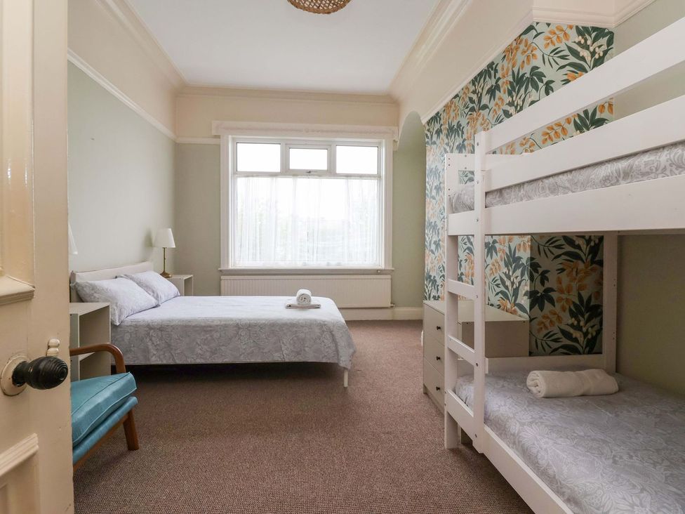 A bedroom with a bed and a bunk bed at Sunrise Lodge in Bridlington