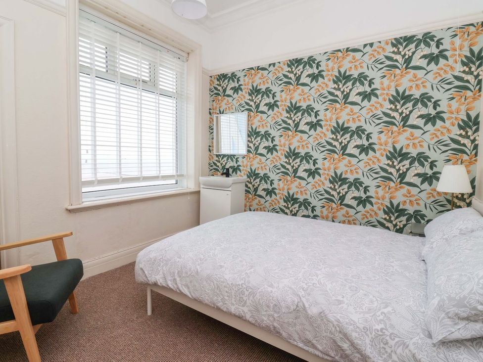 A bedroom with a bed and chair at Sunrise Lodge in Bridlington