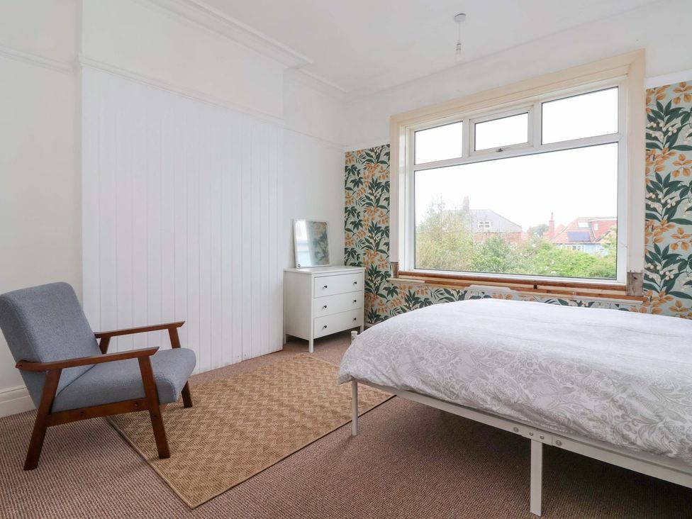 A bedroom with a bed and a chair at Sunrise Lodge in Bridlington
