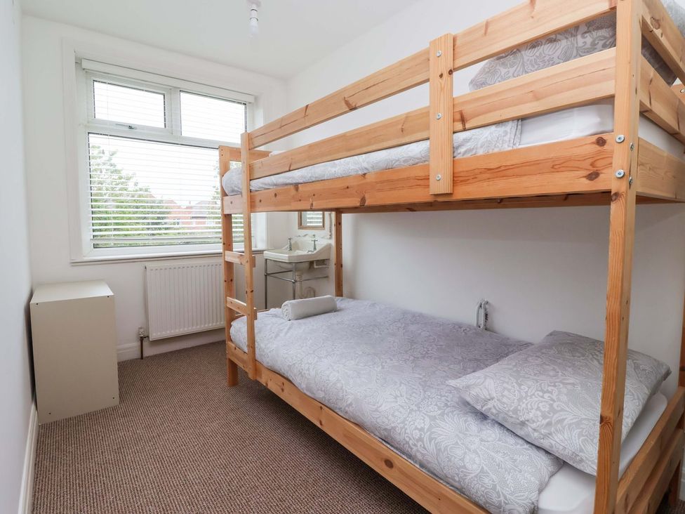 A bedroom with a bunk bed and a radiator at Sunrise Lodge in Bridlington