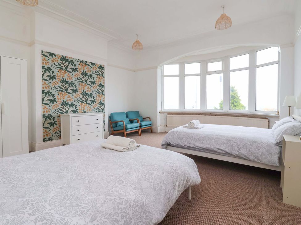 A bedroom with two beds and a dresser at Sunrise Lodge in Bridlington