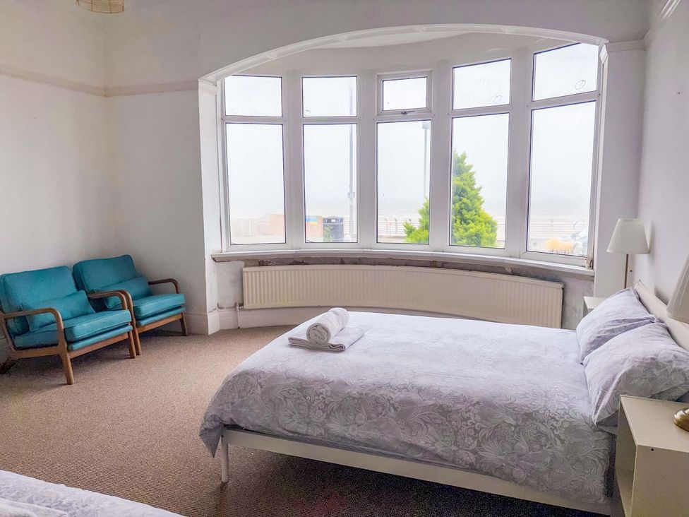 A bedroom with a bed and sofa at Sunrise Lodge in Bridlington