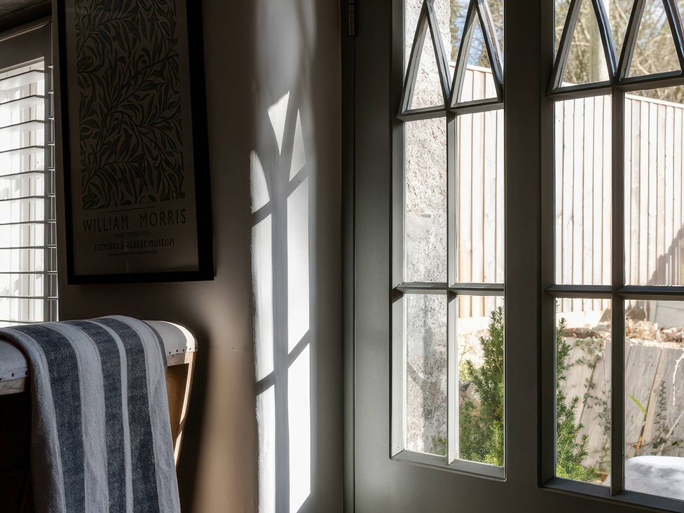 A room with a window and door at Rose Cottage in Gweek