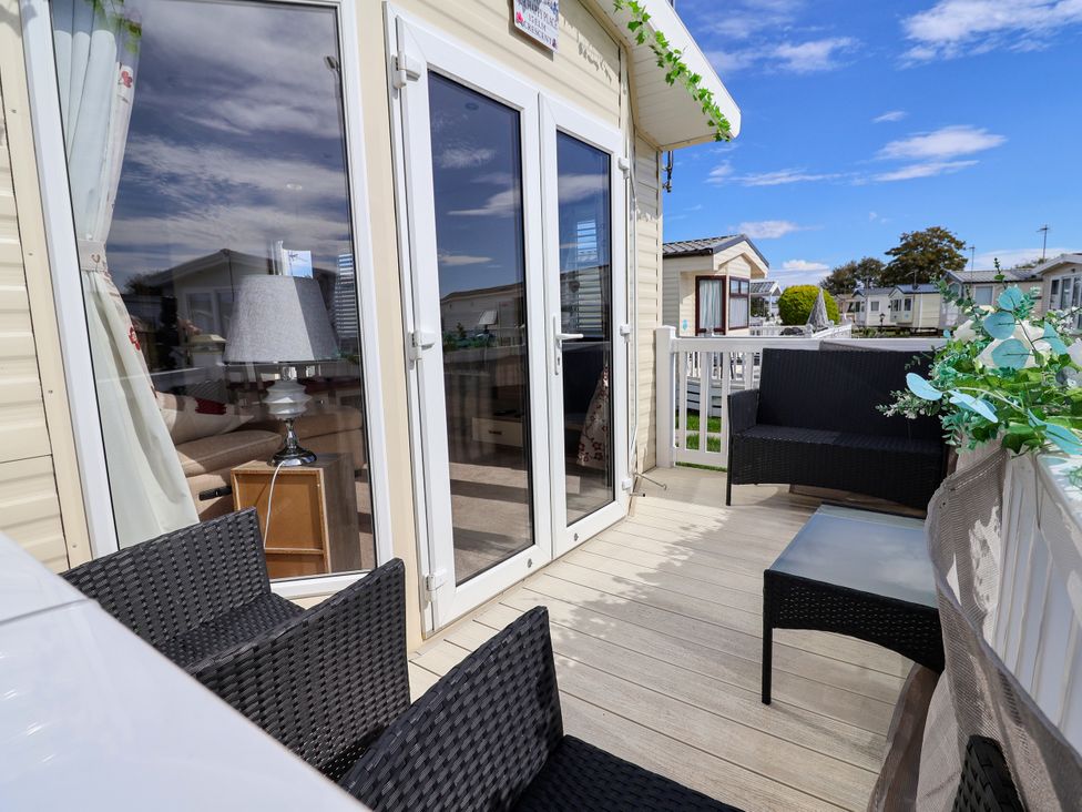 A balcony with chairs and a table at 15 Elm Crescent in Rhyl