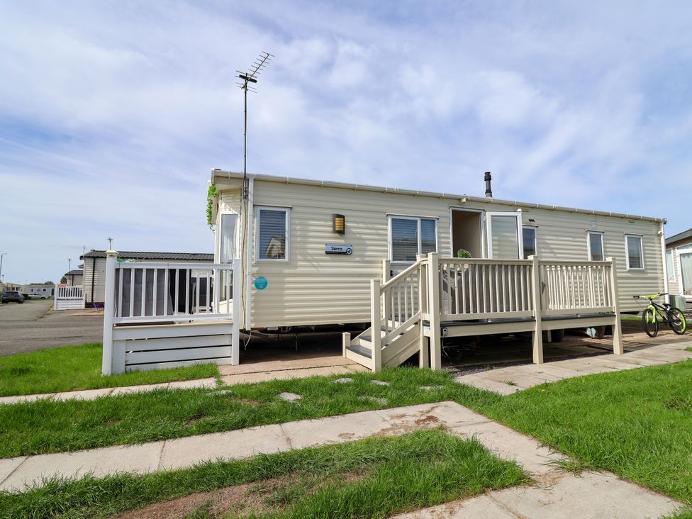 A mobile home with a deck and bicycle at 15 Elm Crescent Rhyl