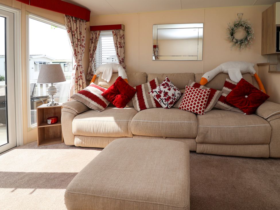 A living room with a sofa and cushions at 15 Elm Crescent Rhyl