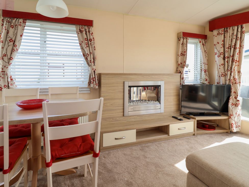 A living room with a fireplace and television at 15 Elm Crescent in Rhyl