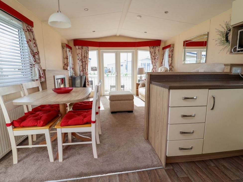 A dining room with a table and chairs at 15 Elm Crescent in Rhyl