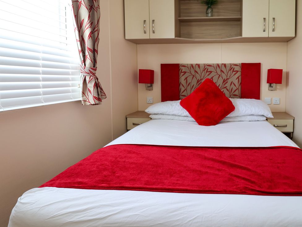 A bedroom with a bed and bedside lamps at 15 Elm Crescent in Rhyl
