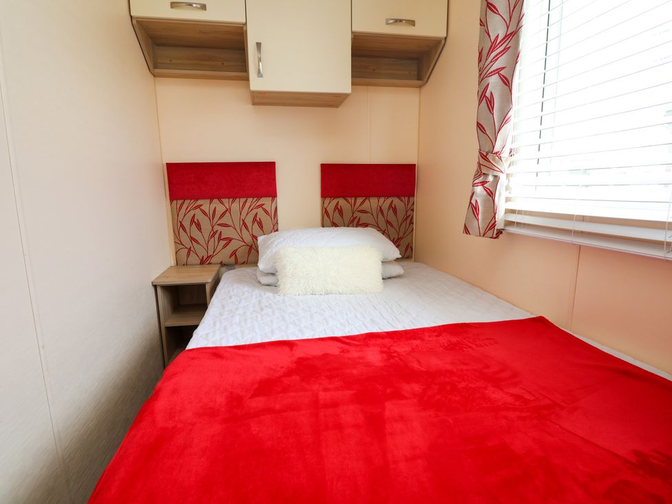 A bedroom with a bed and a bedside table at 15 Elm Crescent in Rhyl