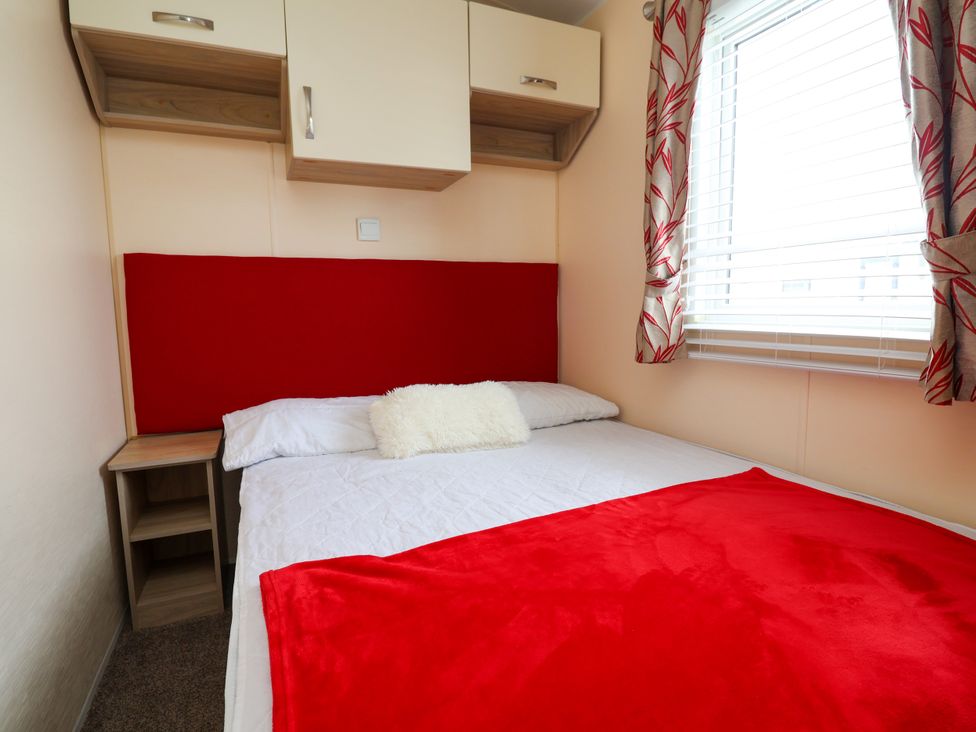 A bedroom with a bed and shelf at 15 Elm Crescent in Rhyl