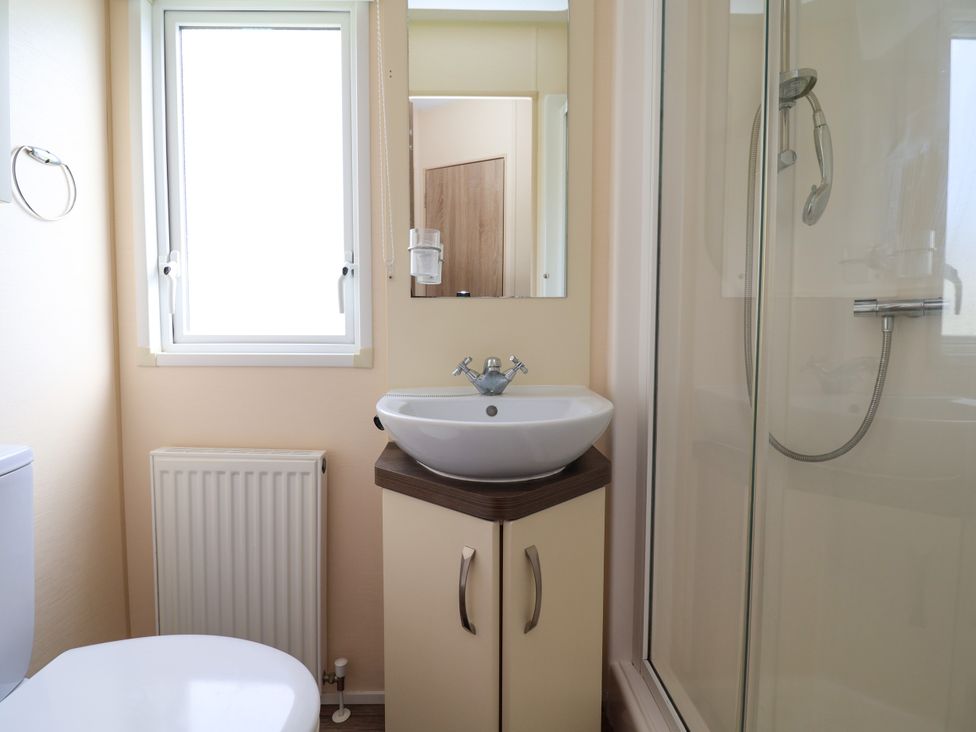 A bathroom with a sink and shower at 15 Elm Crescent in Rhyl