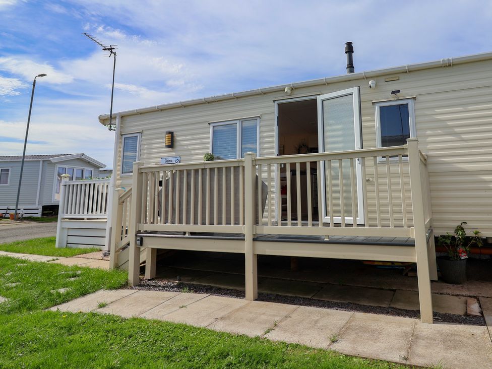 A caravan with a deck and steps at 15 Elm Crescent in Rhyl