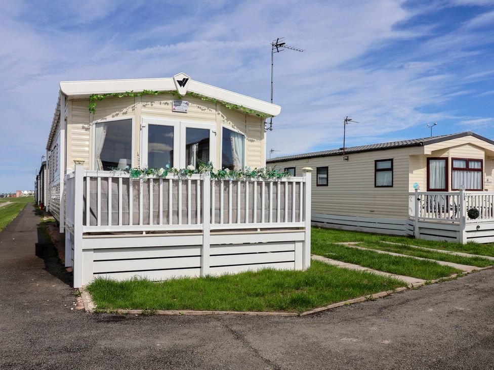 A caravan with a balcony and steps at 15 Elm Crescent in Rhyl