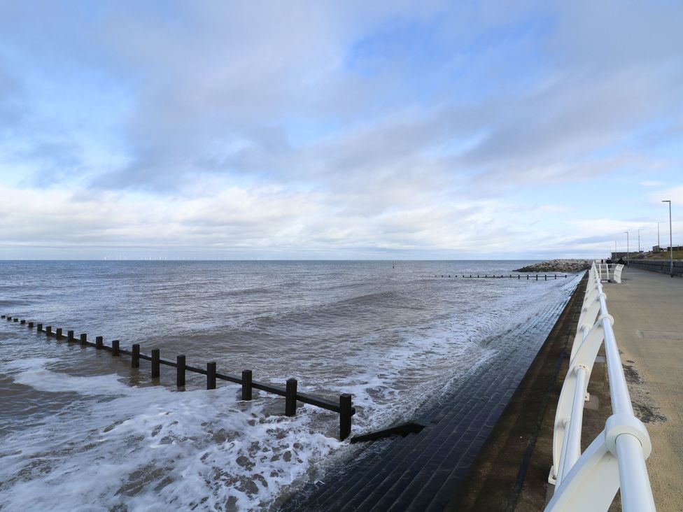 A view of the sea with a pier and walkway at Tidal Retreat in Rhyl