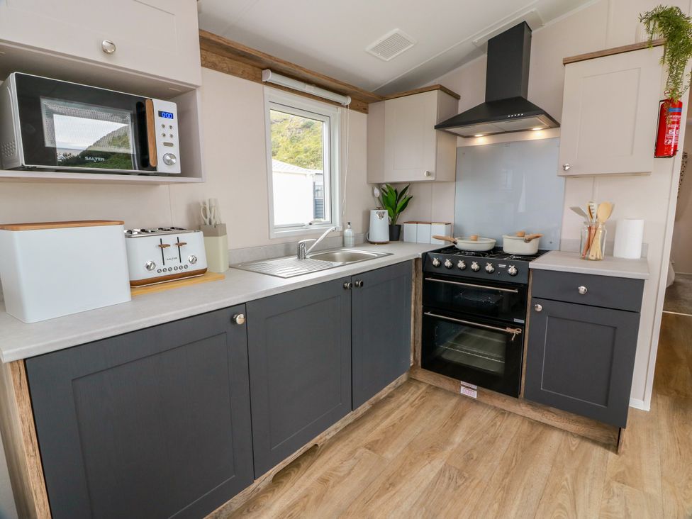 A kitchen with a sink and stove at Caravan in Girvan