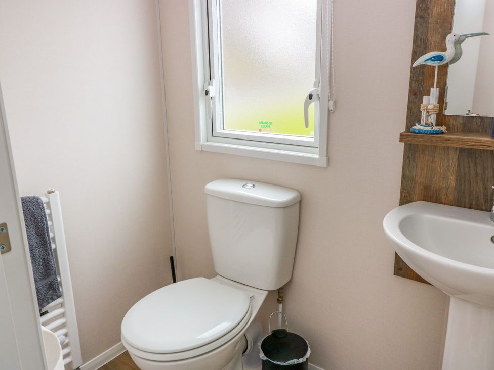 A bathroom with a toilet and sink at Caravan in Girvan