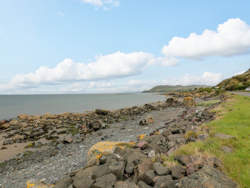 A coastal scene with rocks and grass near the sea at Caravan in Girvan