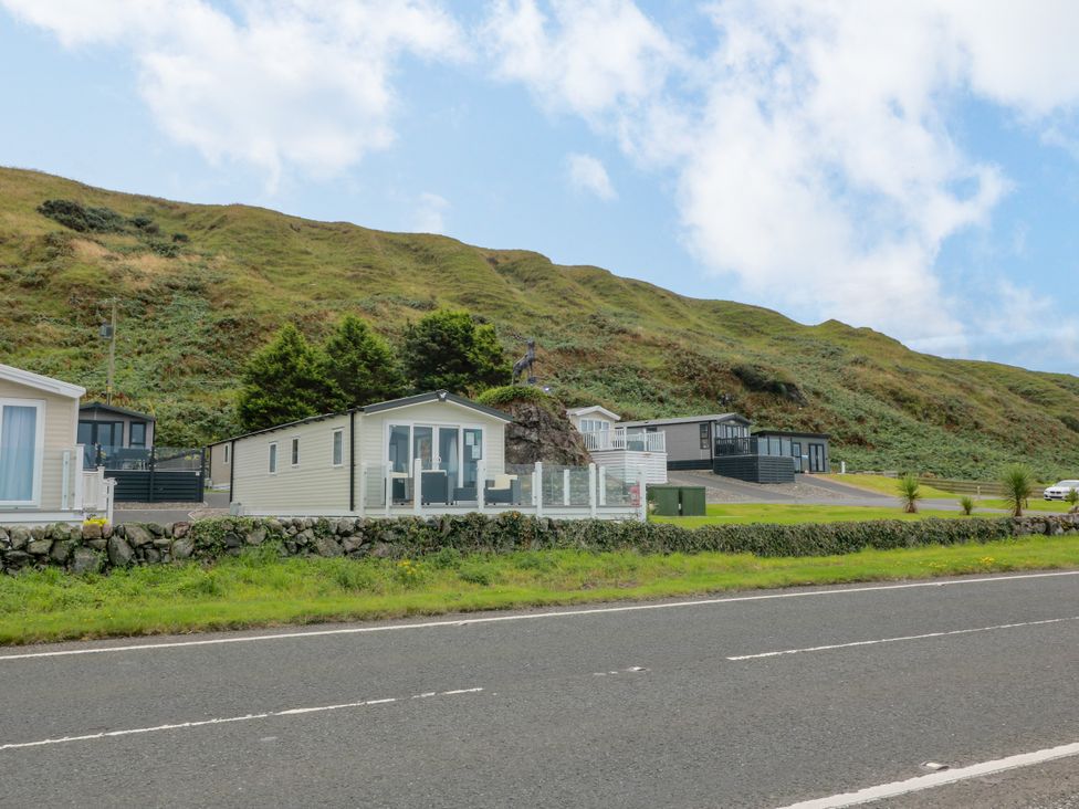 A row of caravans with a hill in the background at Caravan in Girvan