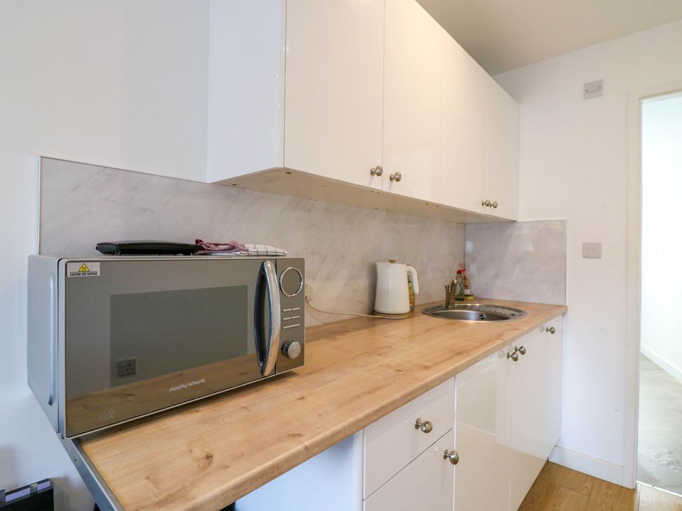 A kitchen with a microwave and kettle at Annex in Southend-On-Sea