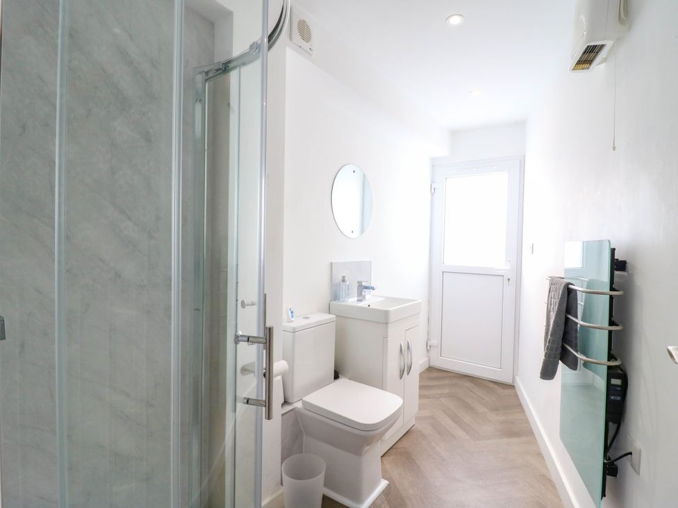 A bathroom with a shower, toilet, and sink at Annex in Southend-On-Sea