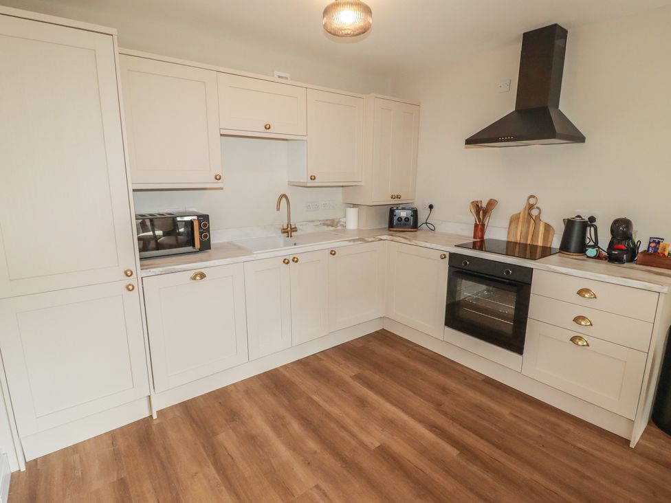 A kitchen with a microwave and oven at Flat 4 in Tenby
