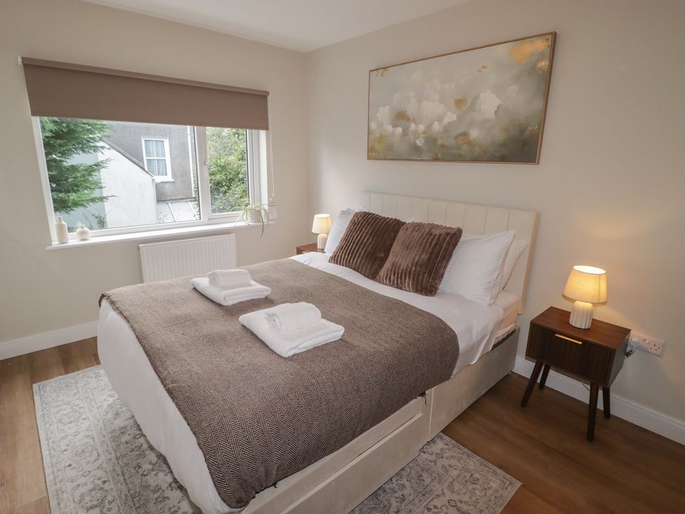A bedroom with a bed and bedside table at Flat 4 in Tenby