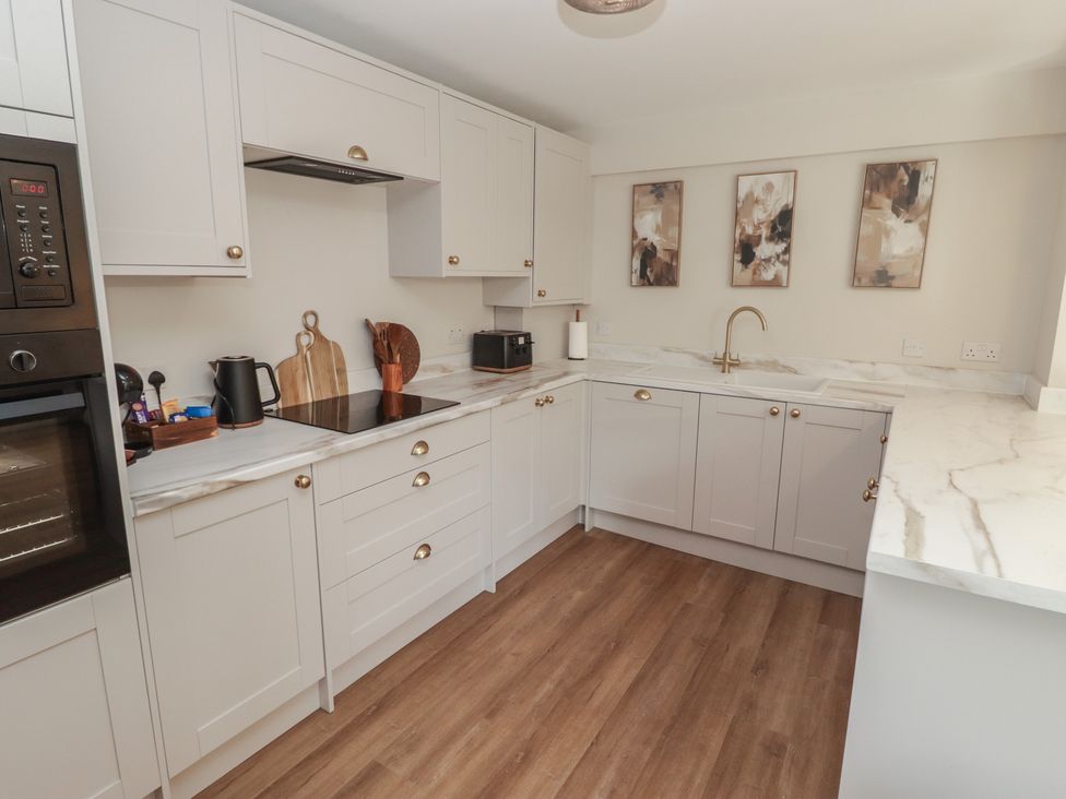 A kitchen with countertop and appliances at Flat 1 Tenby