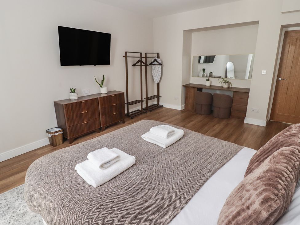 A bedroom with a bed and a television at Flat 1 in Tenby