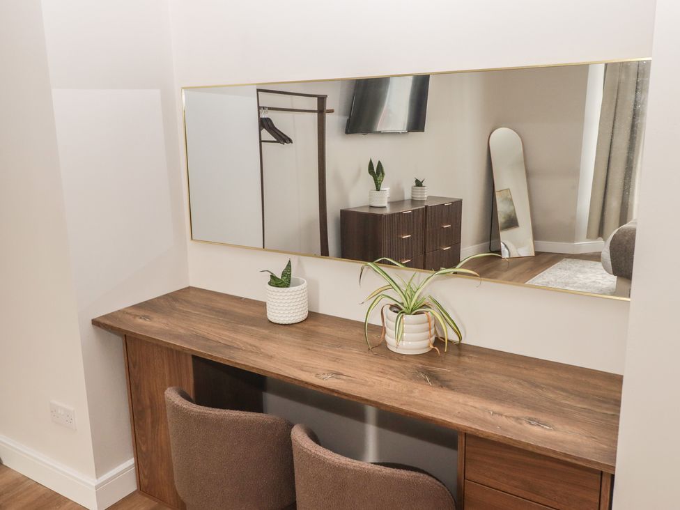 A dressing room with a desk and mirror at Flat 1 in Tenby