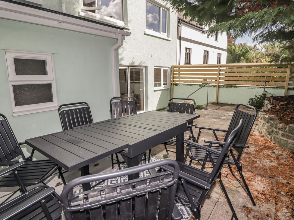 An outdoor space with a table and chairs at Flat 1 in Tenby