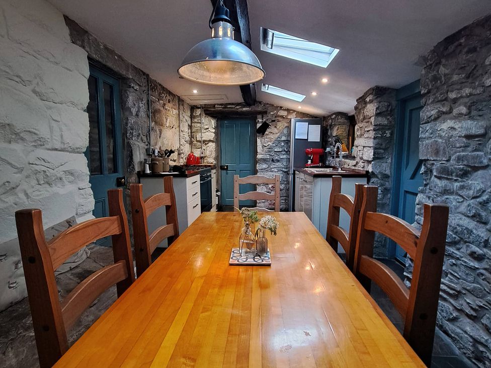 A kitchen with a dining table and chairs at Y Cwtch Dolgellau