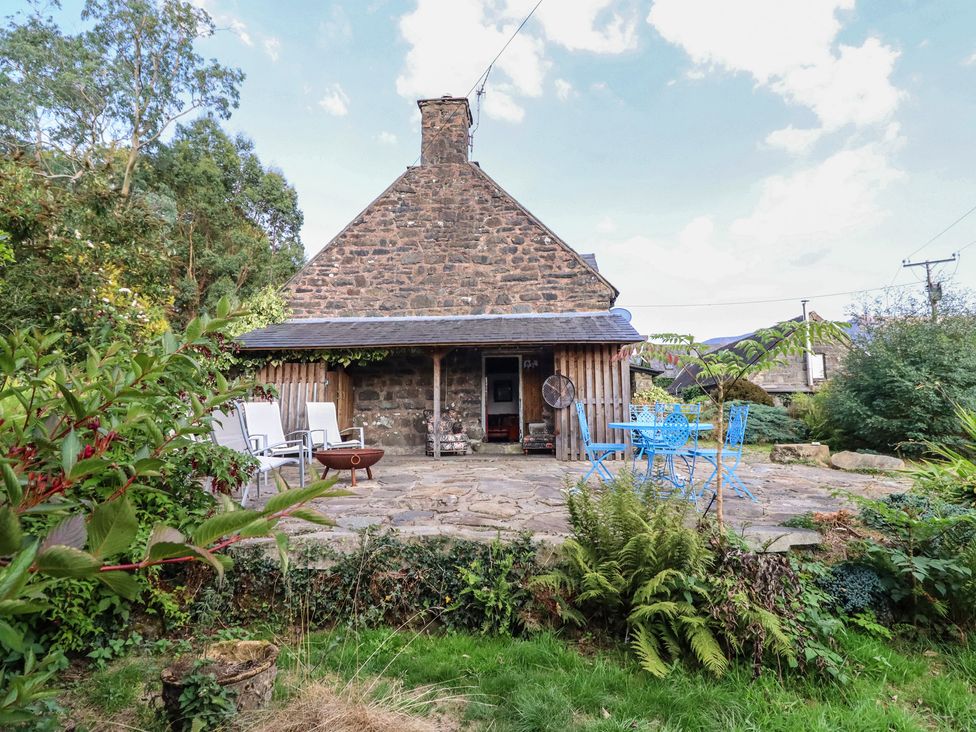 A stone house with a patio and garden at Waen Fechan in Dolgellau