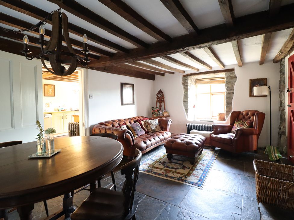 A living room with a sofa and dining table at Waen Fechan in Dolgellau