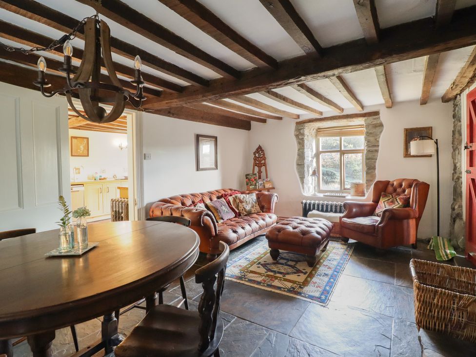 A living room with a dining table and sofa at Waen Fechan in Dolgellau
