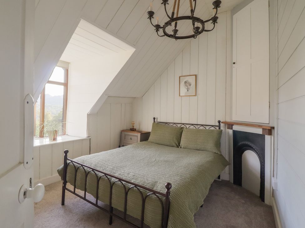 A bedroom with a bed and window at Waen Fechan in Dolgellau