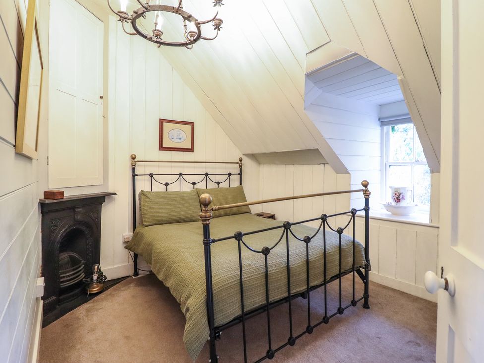 A bedroom with a bed and window at Waen Fechan in Dolgellau