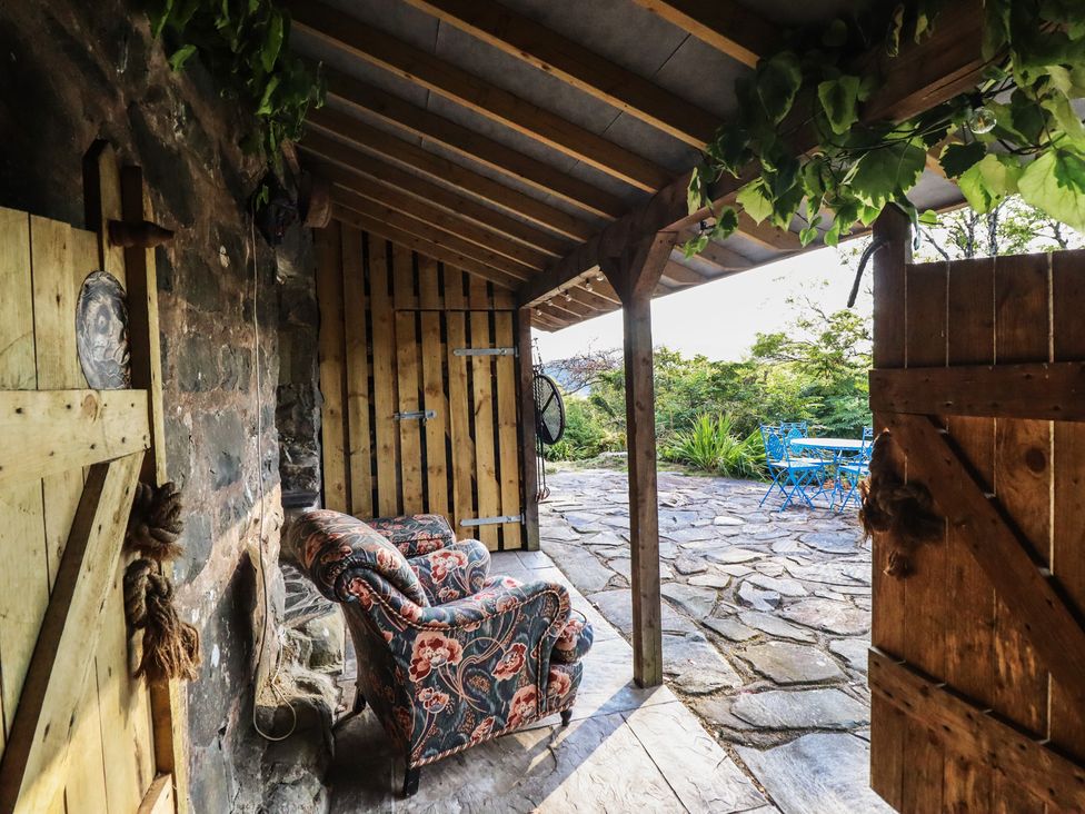 An outdoor area with a chair and a table at Waen Fechan Dolgellau