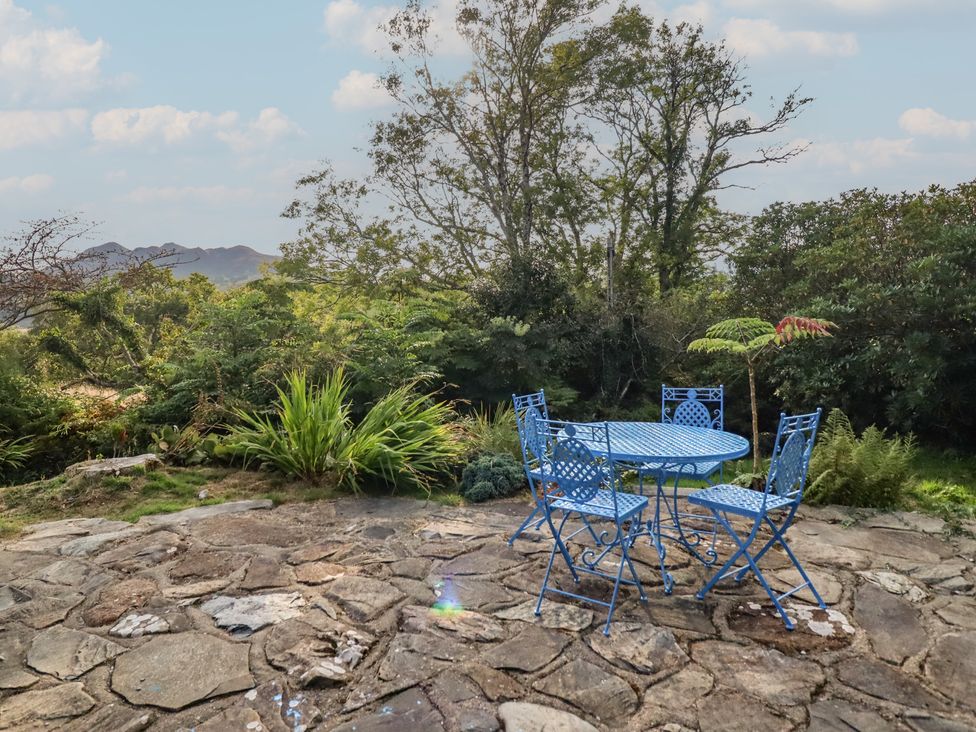 A table and chairs on a stone patio at Waen Fechan in Dolgellau