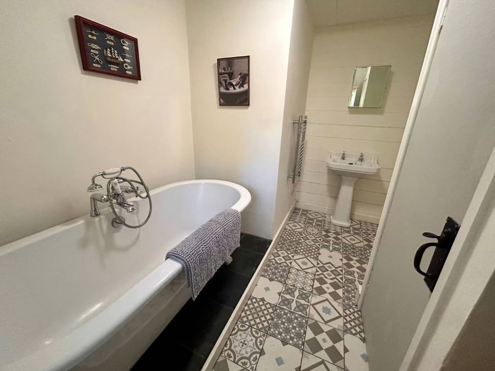 A bathroom with a bathtub and sink at Waen Fechan in Dolgellau