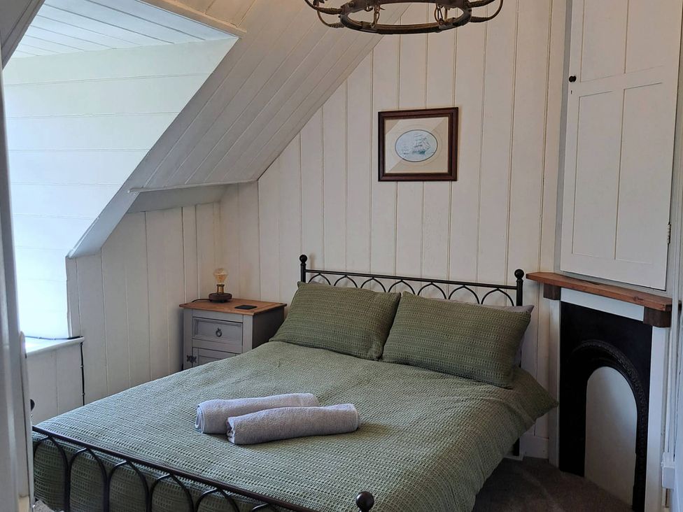 A bedroom with a bed and nightstand at Waen Fechan in Dolgellau