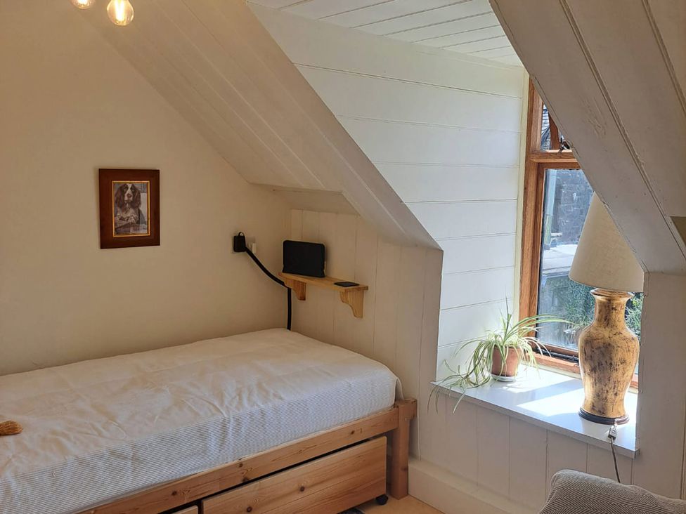 A bedroom with a bed and window at Waen Fechan Dolgellau