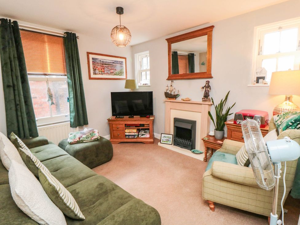 A living room with a television and sofa at 1 St. Anns Lane in Whitby