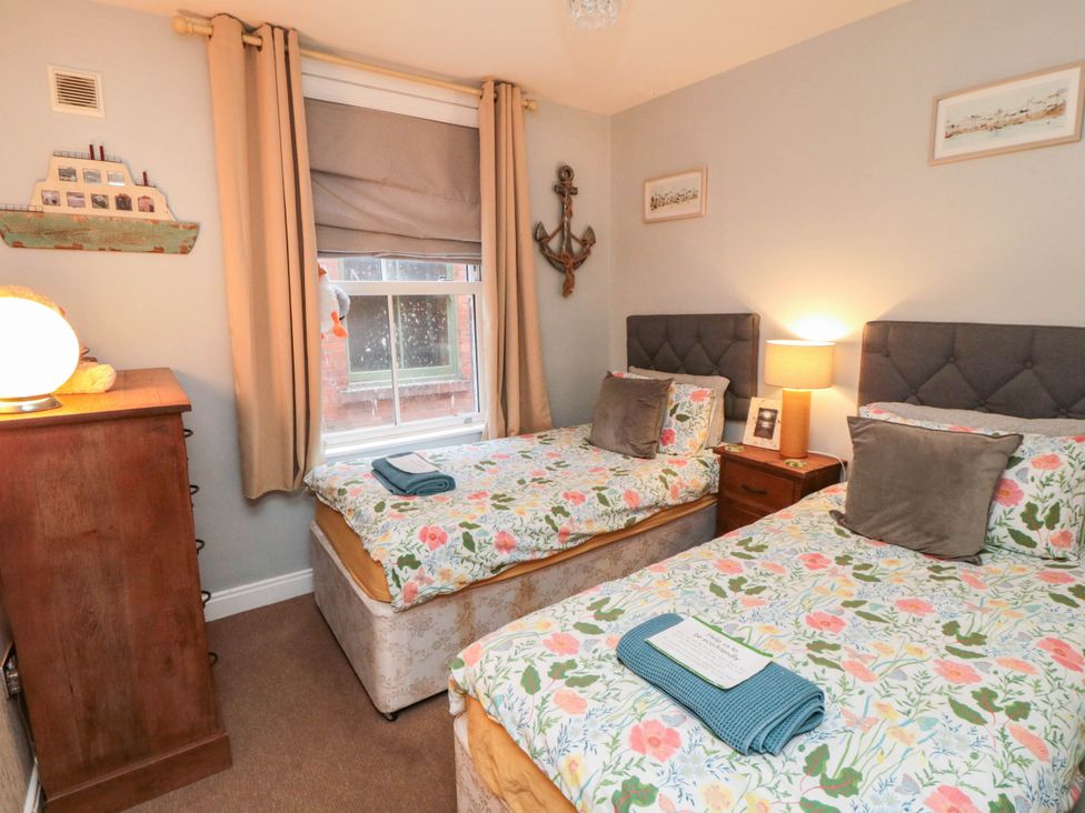 A bedroom with two single beds and a lamp at 1 St. Anns Lane in Whitby