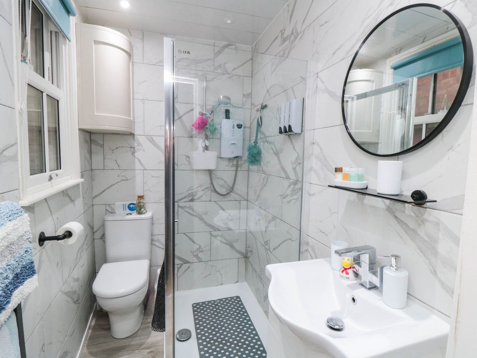A bathroom with a shower, toilet, and sink at 1 St. Anns Lane, Whitby