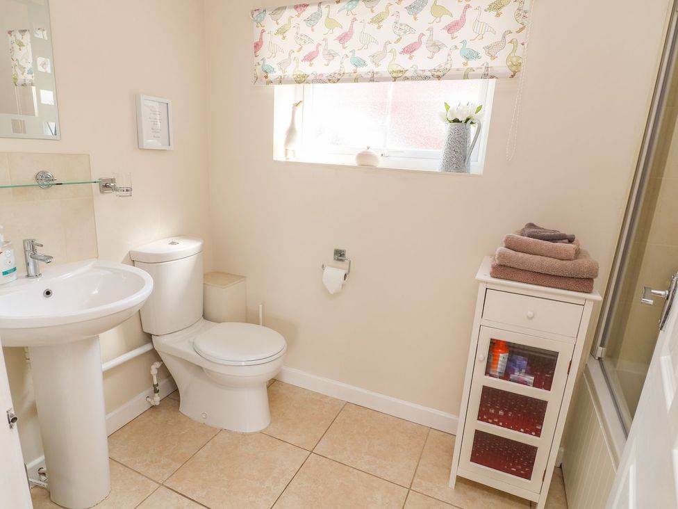 A bathroom with a sink and toilet at The Byre in Ashbourne