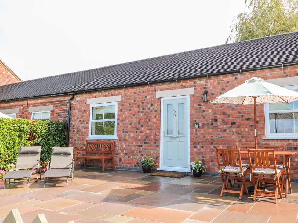 An outdoor seating area with chairs and a table at The Croft in Ashbourne