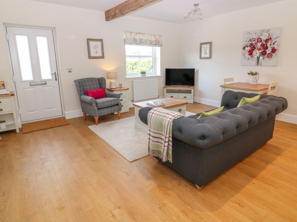 A living room with a couch and armchair at The Croft in Ashbourne