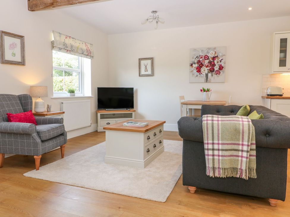 A living room with a sofa and armchair at The Croft in Ashbourne