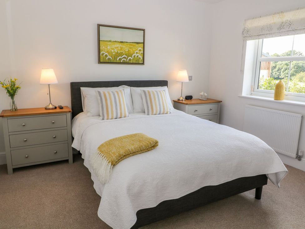A bedroom with a bed and nightstands at The Croft in Ashbourne